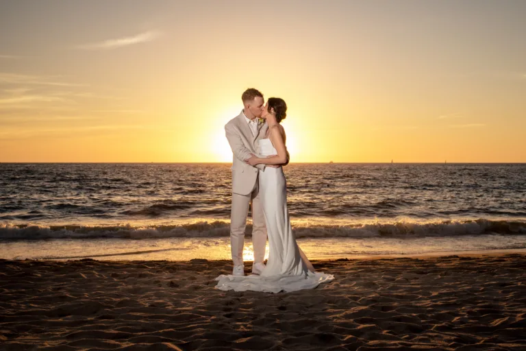 Bride and groom on the beach at sunset