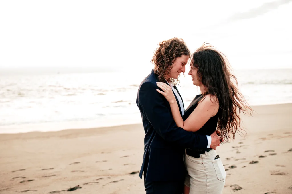 Couple embracing on the beach in soft light