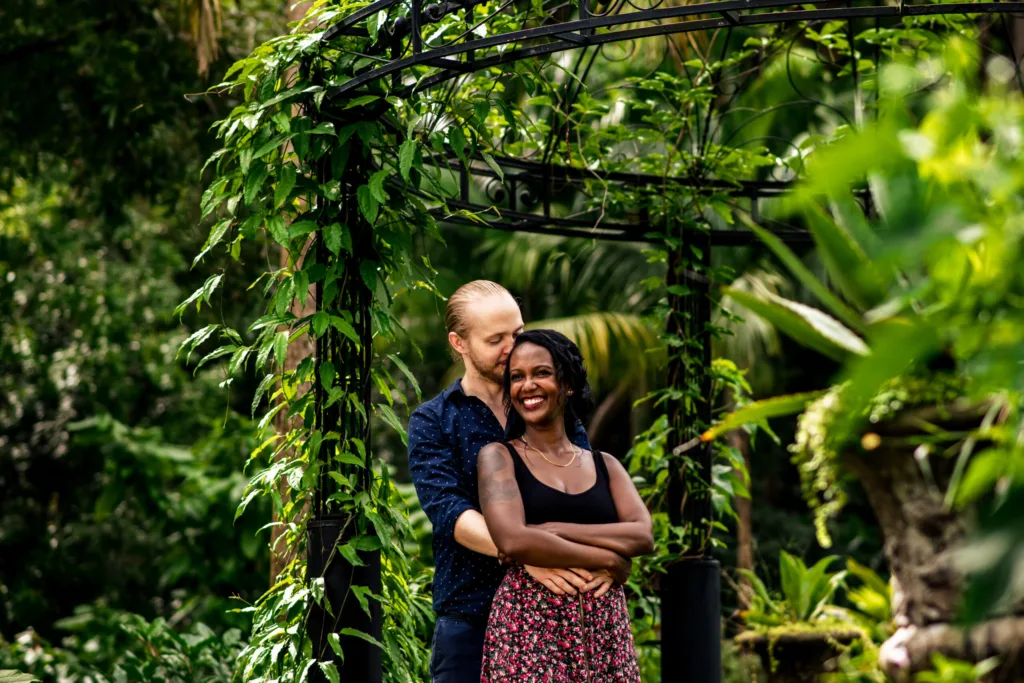 Couple hugging in a lush garden