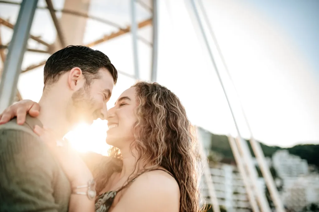 Couple about to kiss in the sunlight on a boat
