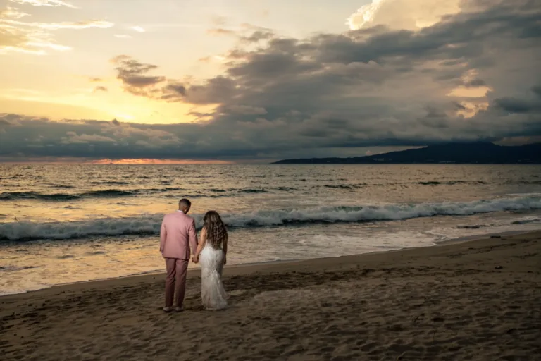 Couple walking on the beach at sunset