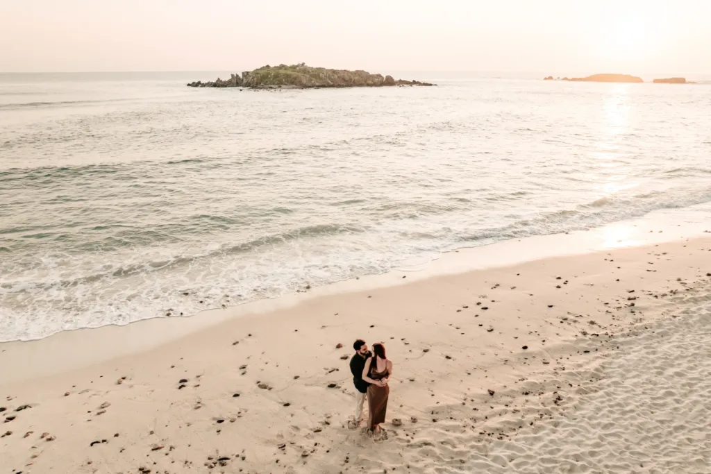Couple on a wide beach at sunrise